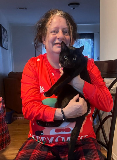woman holding a black cat